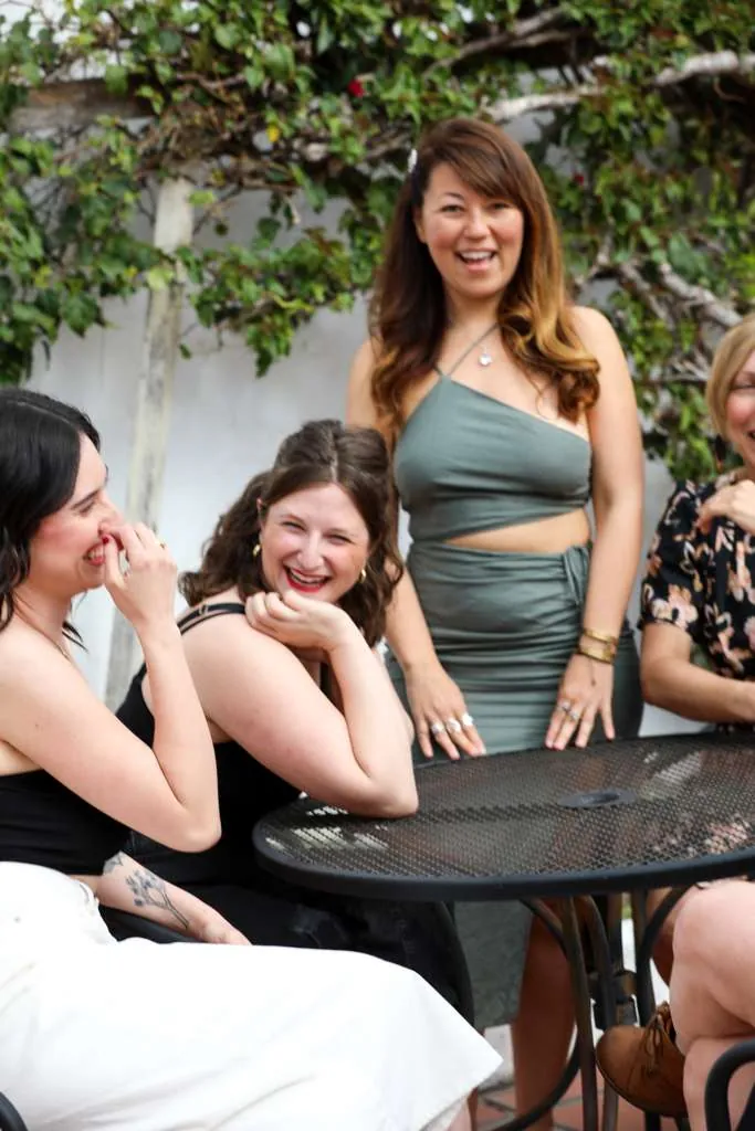 Women laughing around a garden table